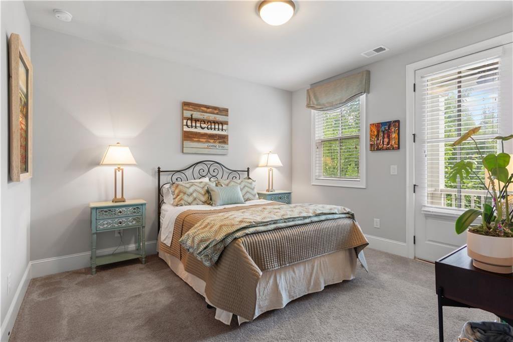 126 Academy Street Alpharetta, GA 30009 - Photo 48 of 74 a bedroom with a bed and a potted plant