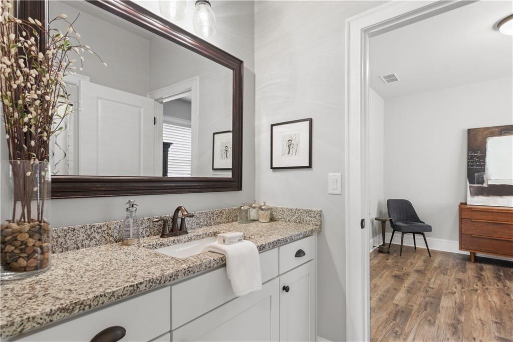 126 Academy Street Alpharetta, GA 30009 - Photo 50 of 74 a bathroom with a granite countertop sink and a mirror