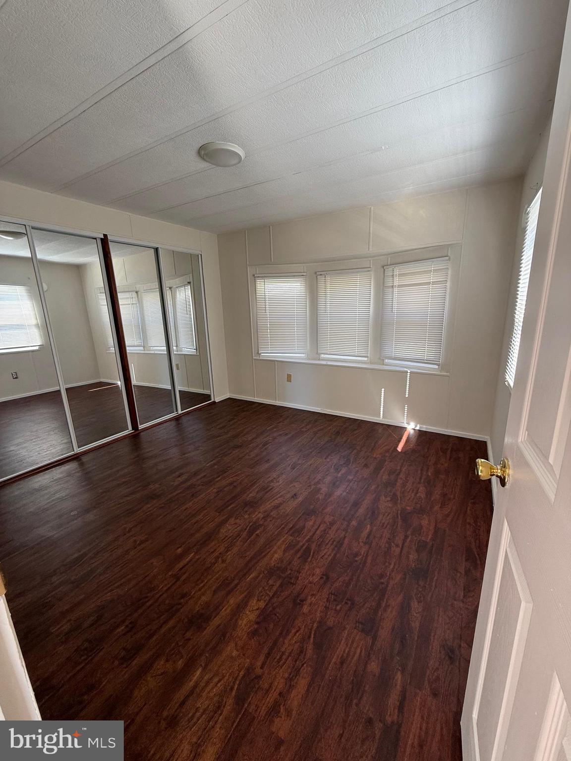 6095 Chan Place La Plata, MD 20646 - Photo 7 of 9 an empty room with wooden floor and windows