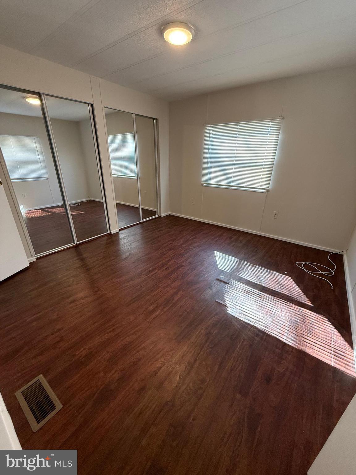6095 Chan Place La Plata, MD 20646 - Photo 9 of 9 an empty room with wooden floor and windows