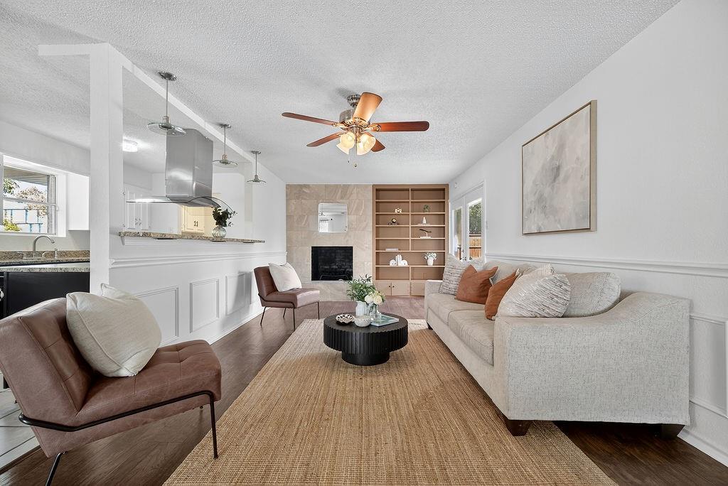 9662 Ferndale Road Dallas, TX 75238 - Photo 13 of 39 a living room with furniture a fireplace and a potted plant