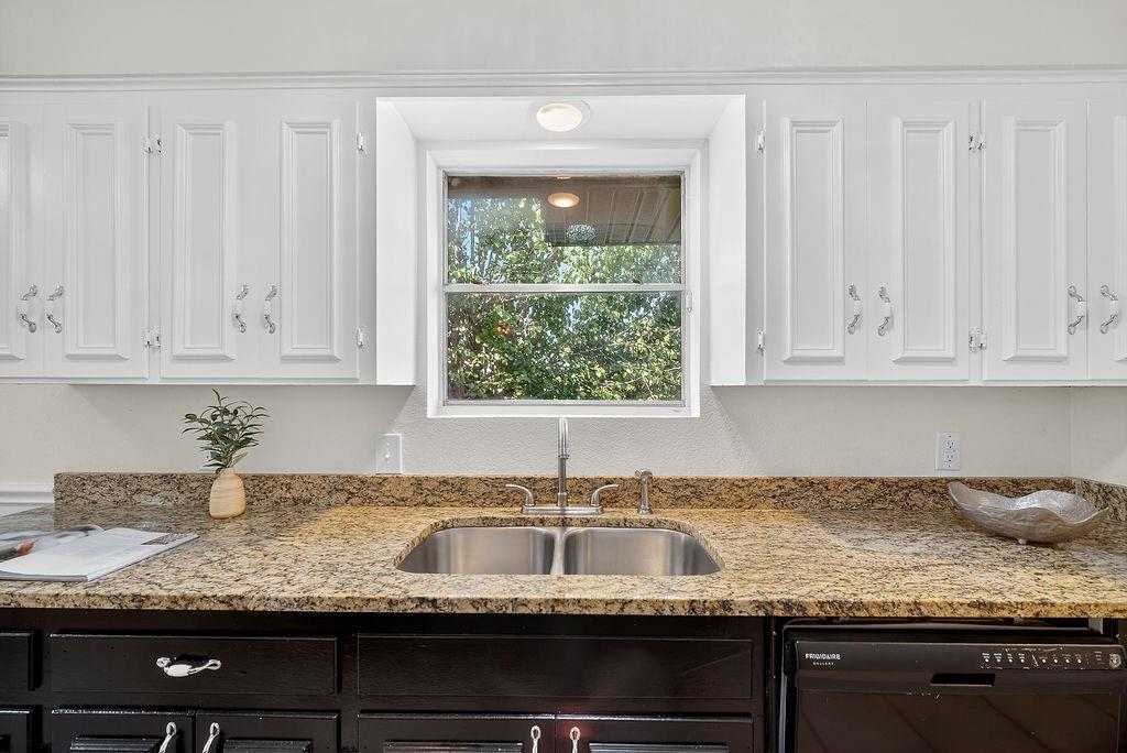 9662 Ferndale Road Dallas, TX 75238 - Photo 15 of 39 a kitchen with granite countertop white cabinets and a sink