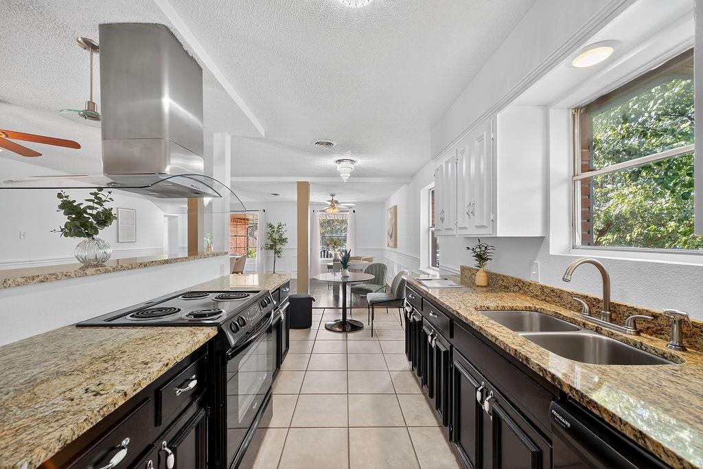 9662 Ferndale Road Dallas, TX 75238 - Photo 17 of 39 a kitchen with stainless steel appliances granite countertop a sink stove and cabinets