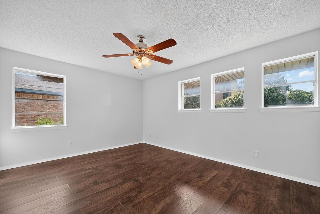 9662 Ferndale Road Dallas, TX 75238 - Photo 26 of 39 a view of an empty room with wooden floor and a window