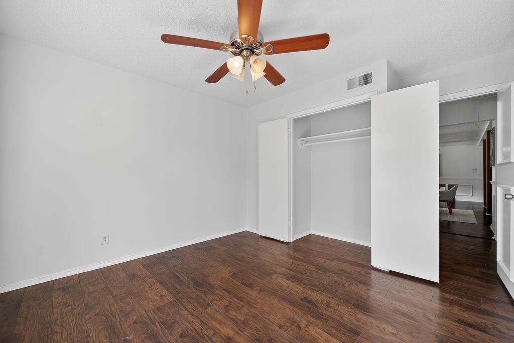 9662 Ferndale Road Dallas, TX 75238 - Photo 27 of 39 a view of a livingroom with wooden floor and a ceiling fan