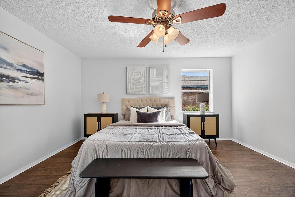 9662 Ferndale Road Dallas, TX 75238 - Photo 31 of 39 a bedroom with a bed a window and lamps