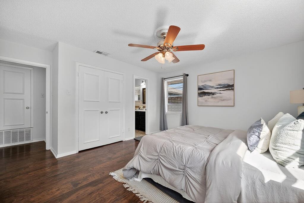9662 Ferndale Road Dallas, TX 75238 - Photo 32 of 39 a bedroom with a bed and wooden floor