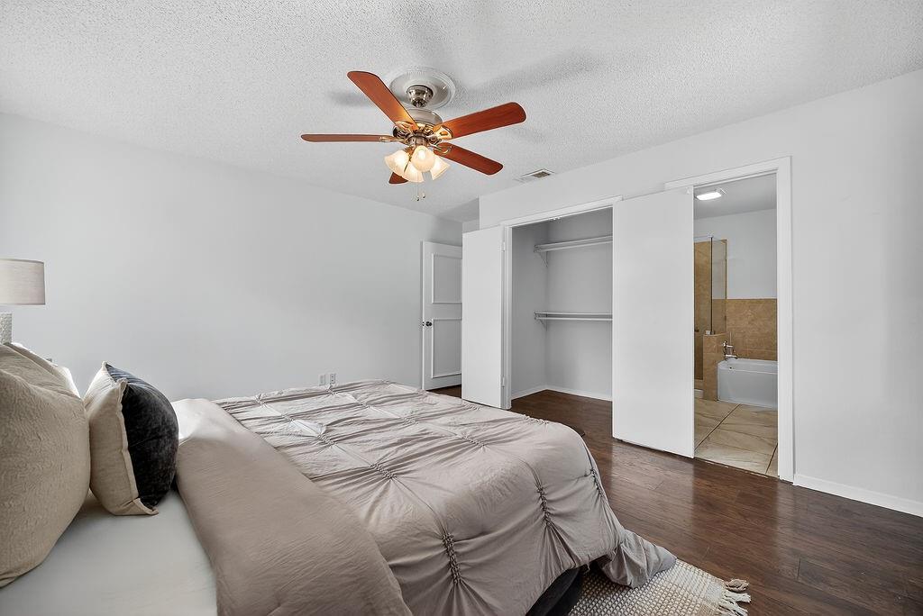 9662 Ferndale Road Dallas, TX 75238 - Photo 33 of 39 a bedroom with a bed and wooden floor