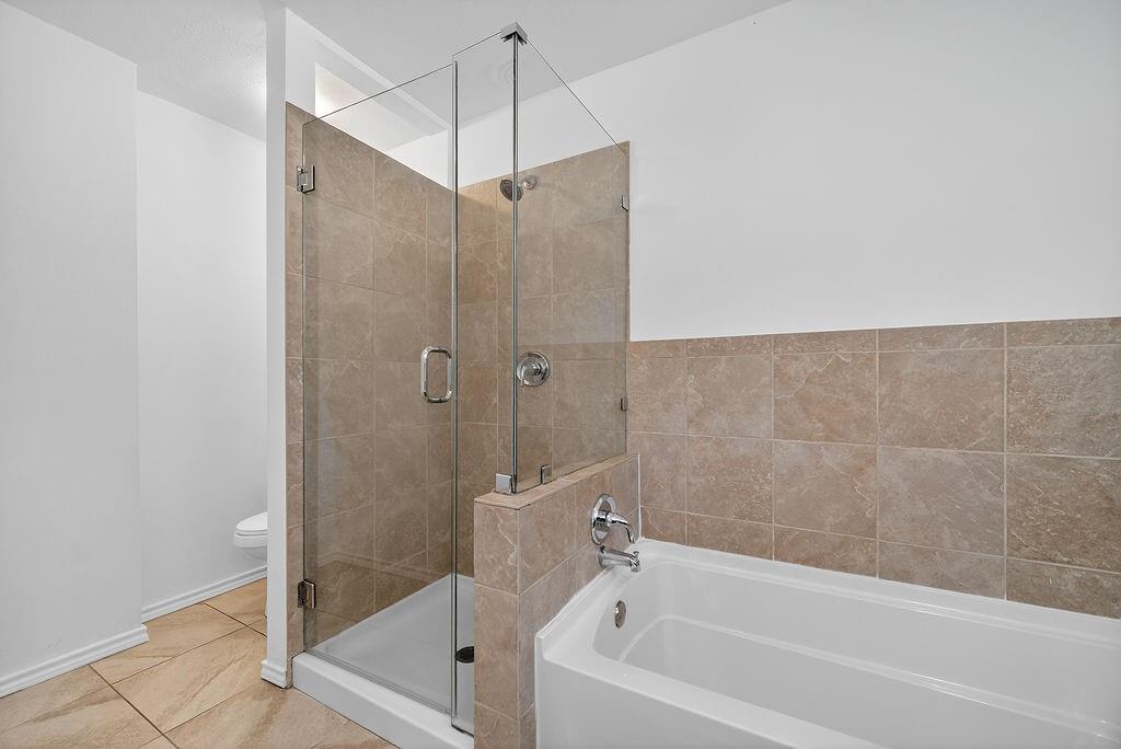 9662 Ferndale Road Dallas, TX 75238 - Photo 35 of 39 a bathroom with a bathtub and a shower