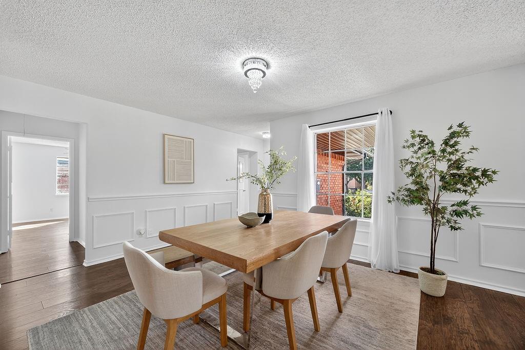 9662 Ferndale Road Dallas, TX 75238 - Photo 9 of 39 a view of a dining room with furniture and wooden floor