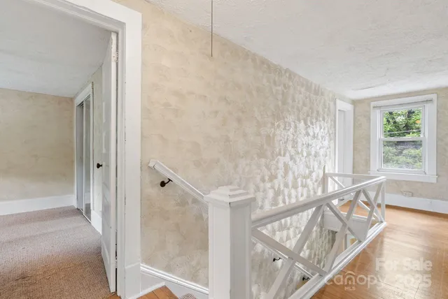 a view of staircase with white walls and a window