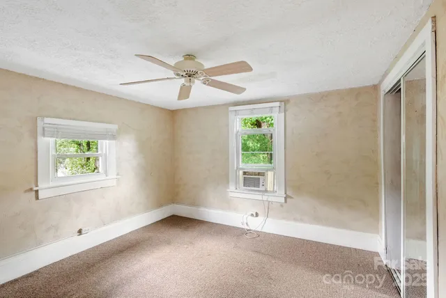 a view of an empty room with a window