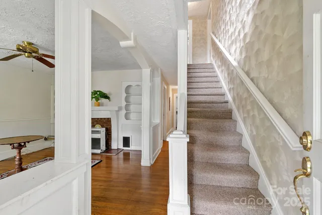 a view of entryway and hall with wooden floor