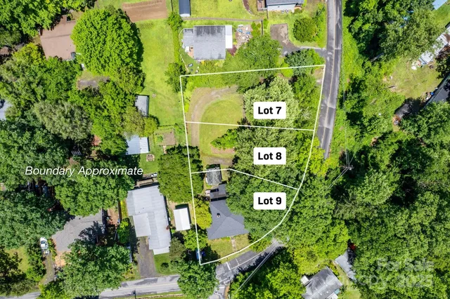 an aerial view of a building and trees all around