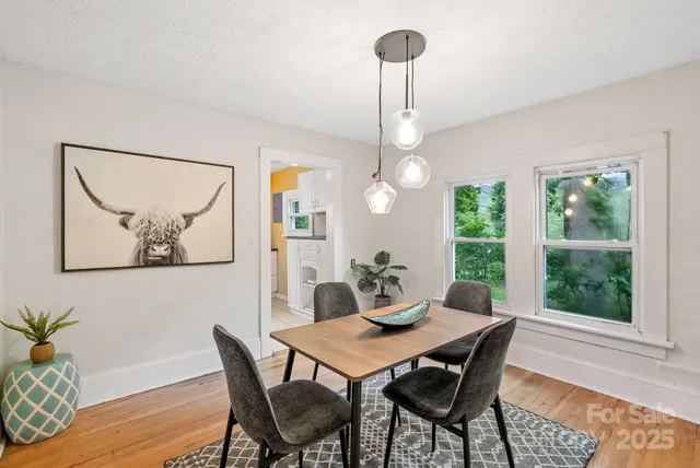 a view of a dining room with furniture window and wooden floor