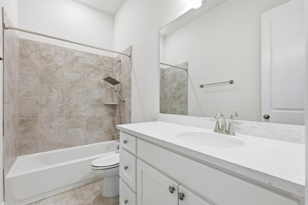 3968 Sevilla Drive Frisco, TX 75034 - Photo 13 of 38 a bathroom with a sink a toilet and a bathtub