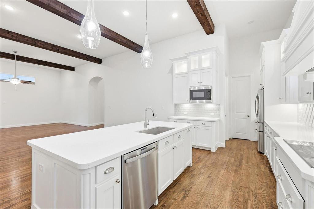 3968 Sevilla Drive Frisco, TX 75034 - Photo 19 of 38 a kitchen with a sink stove and refrigerator