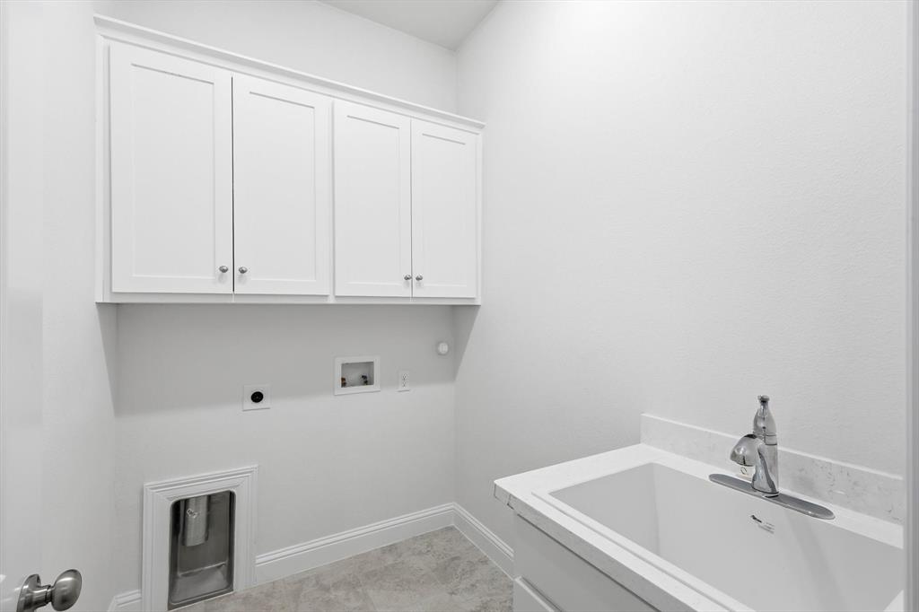 3968 Sevilla Drive Frisco, TX 75034 - Photo 20 of 38 a bathroom with a sink and cabinets