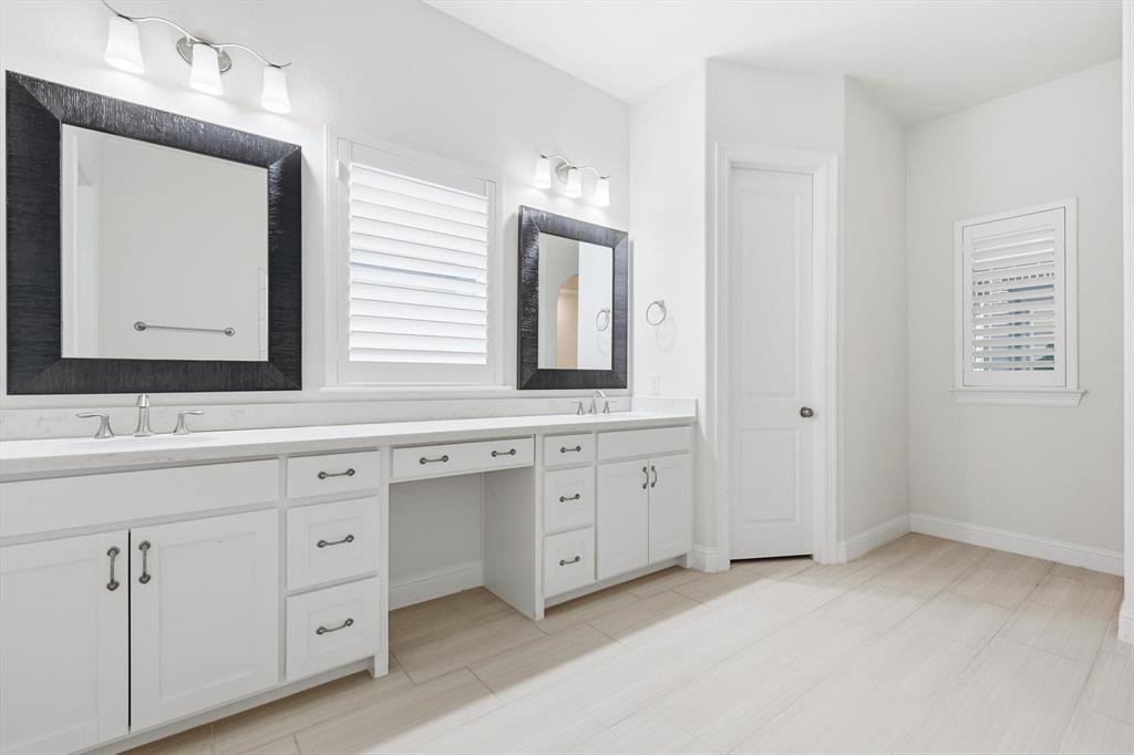 3968 Sevilla Drive Frisco, TX 75034 - Photo 25 of 38 a bathroom with a double vanity sink and mirror