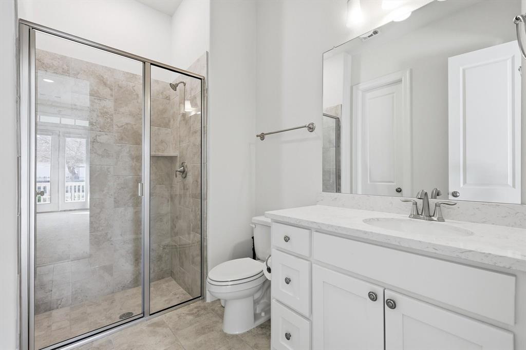 3968 Sevilla Drive Frisco, TX 75034 - Photo 9 of 38 a bathroom with a shower sink vanity mirror and toilet