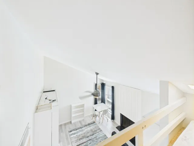 a white kitchen with refrigerator a microwave and sink