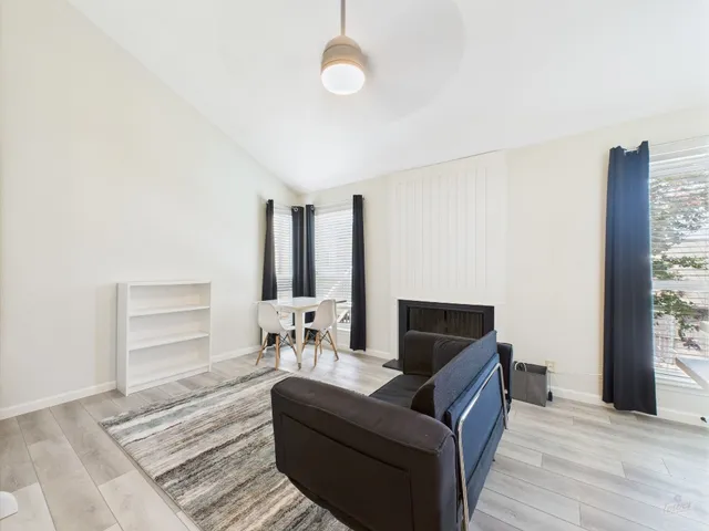 a living room with furniture and a floor to ceiling window
