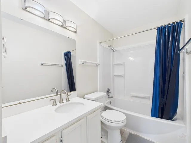 a large white bed in a white room