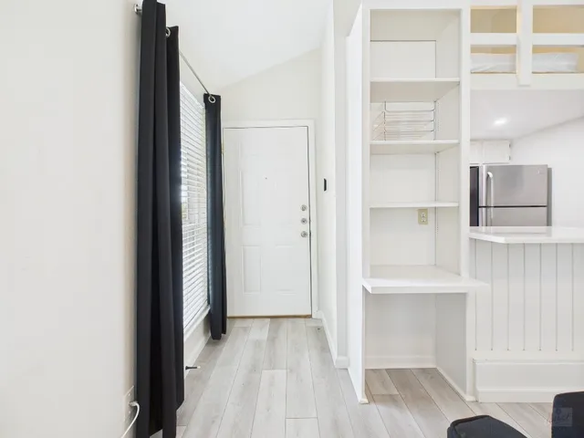 a view of hallway with wooden floor