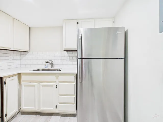 a white refrigerator freezer sitting inside of a kitchen