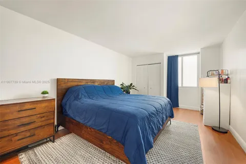 a bedroom with a bed and dresser