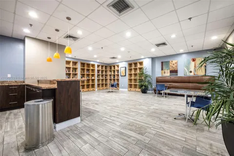 a living room with furniture a dining table and chairs with wooden floor