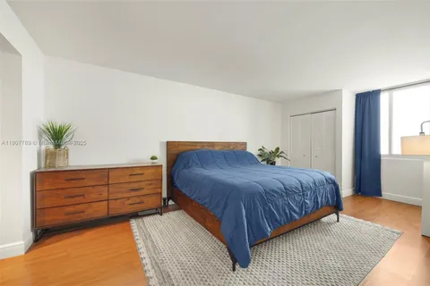 a bedroom with a bed and dresser