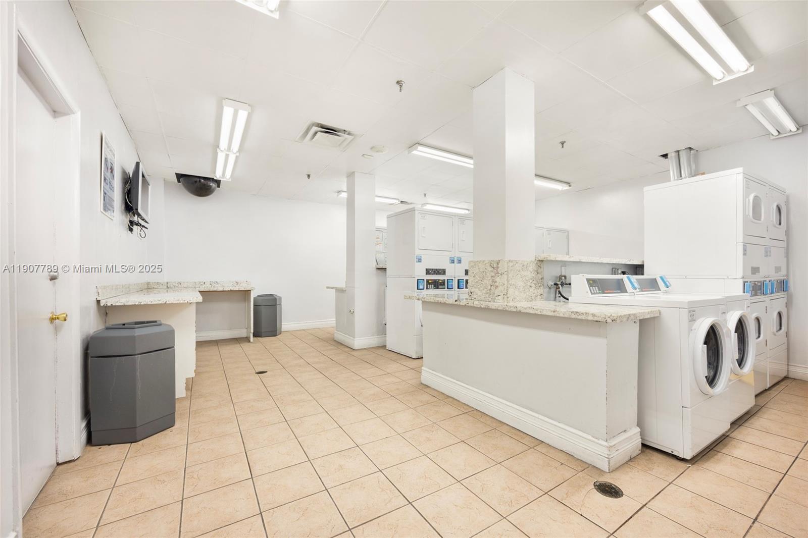 850 North Miami Avenue, Unit W906 Miami, FL 33136 - Photo 6 of 23 a kitchen with white cabinets and white appliances