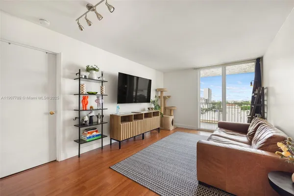 a living room with furniture and a flat screen tv