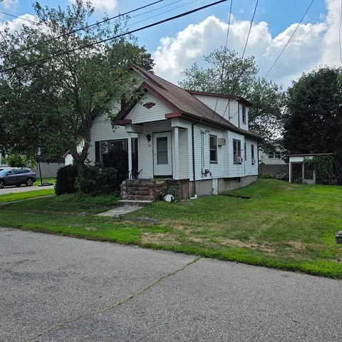 a front view of house with yard and green space