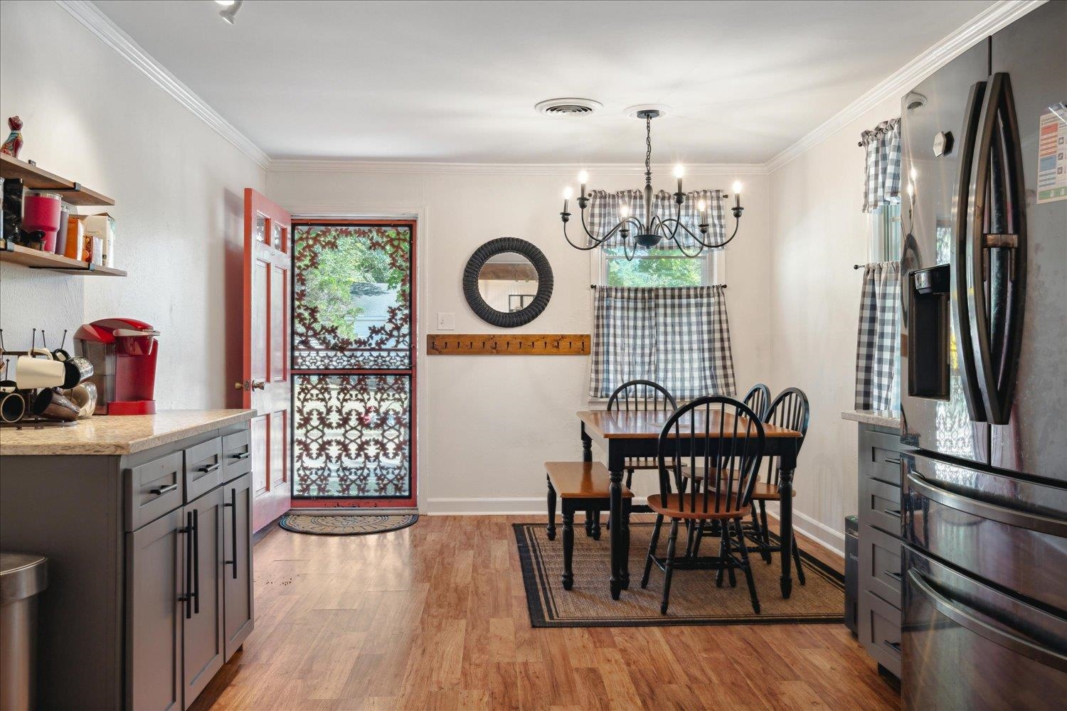 977 Waring Road Memphis, TN 38122 - Photo 4 of 32 Dining room with an inviting chandelier, light hardwood / wood-style flooring, and ornamental molding