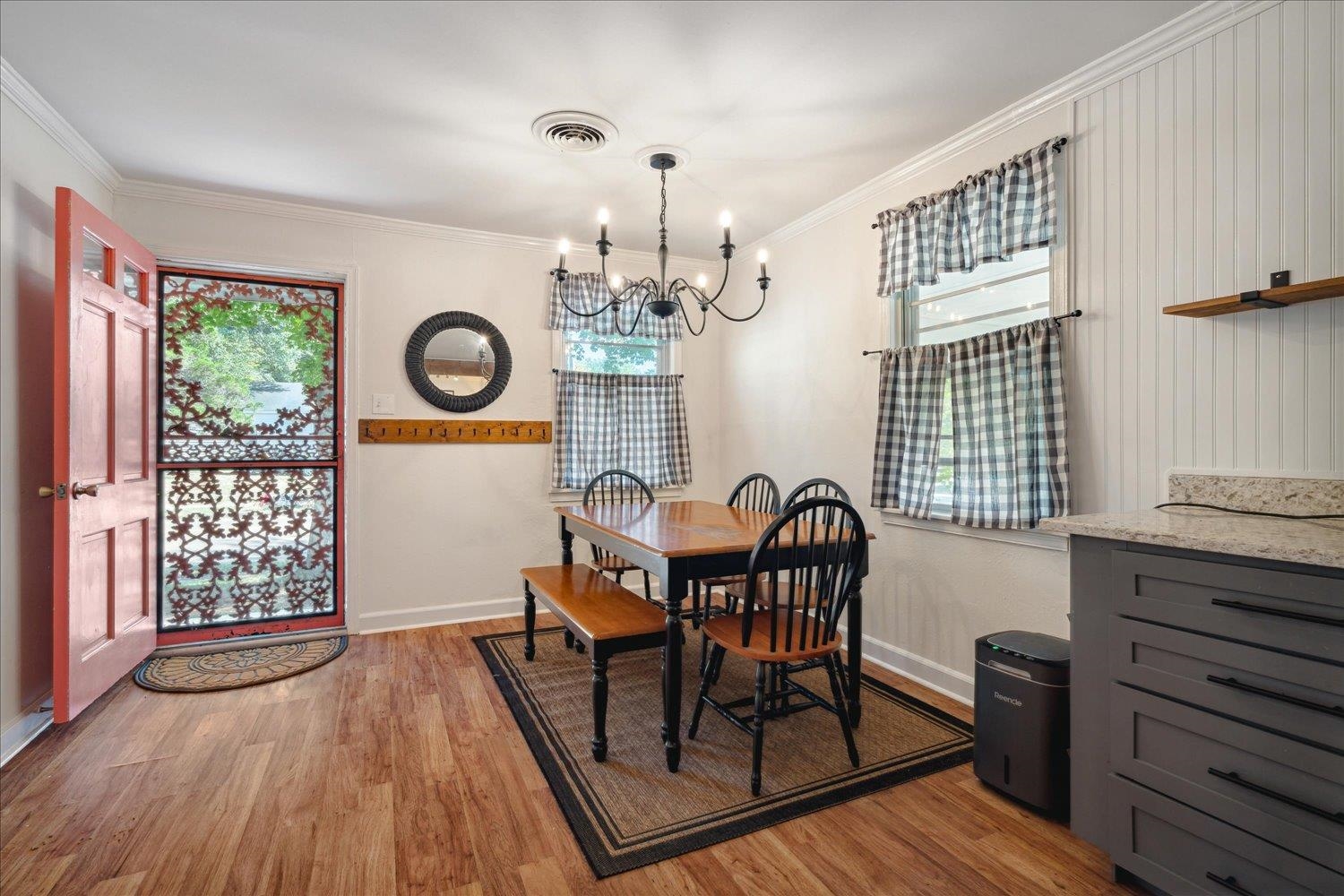 977 Waring Road Memphis, TN 38122 - Photo 5 of 32 Dining area featuring crown molding, wood-type flooring, and an inviting chandelier