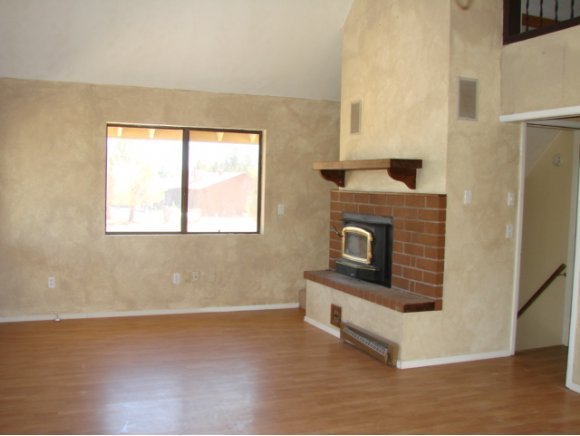 2817 North Reed Road Chino Valley, AZ 86323 - Photo 8 of 18 a living room with stainless steel appliances wooden floor and a fireplace