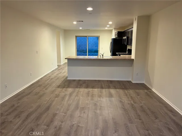 a view of kitchen with kitchen island microwave and sink