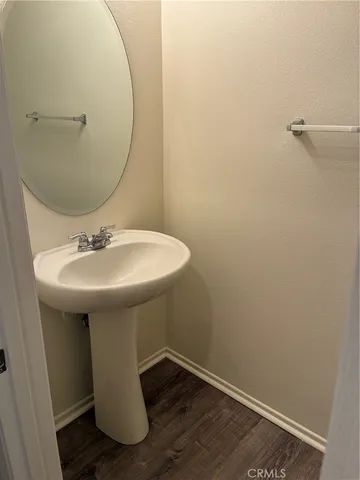 a bathroom with a sink toilet and mirror