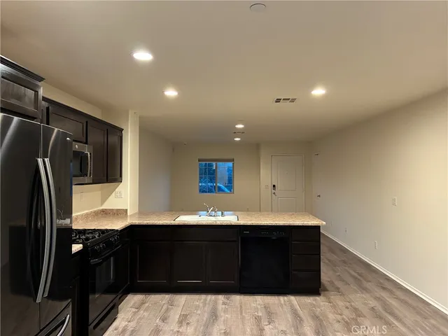 a kitchen with a sink and a refrigerator