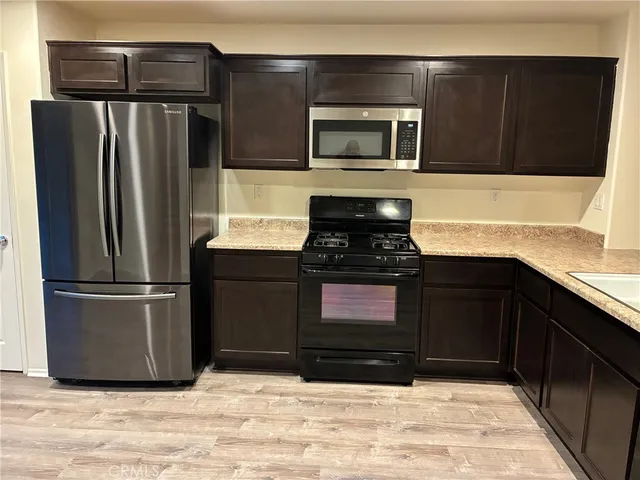 a kitchen with a refrigerator stove and microwave