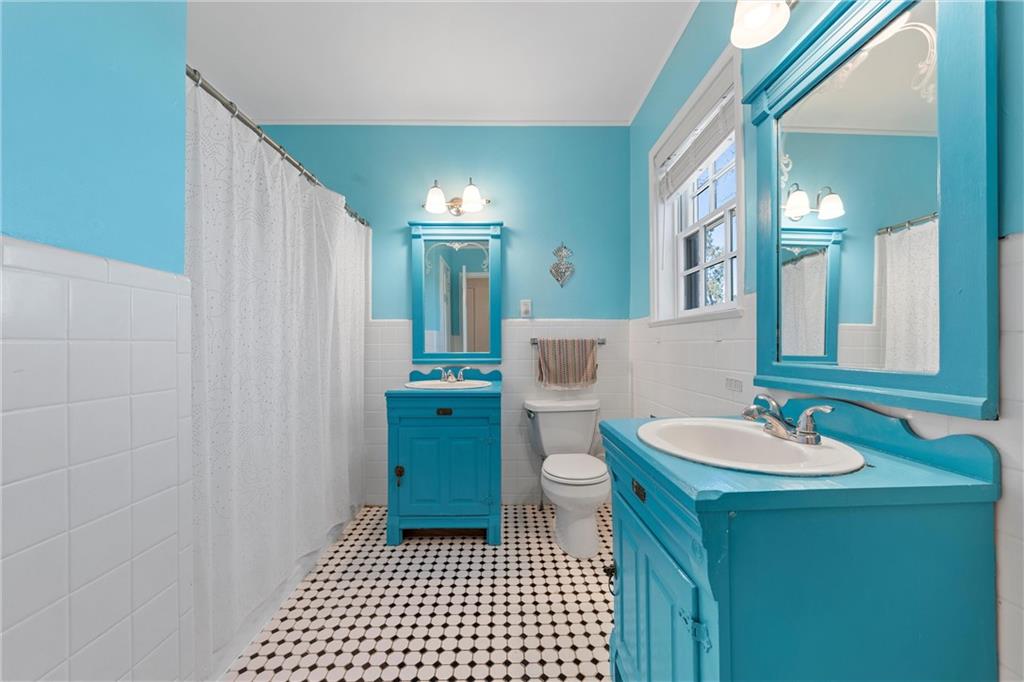 2737 Cumberland Avenue Waco, TX 76708 - Photo 34 of 45 a bathroom with a sink a toilet a mirror and shower