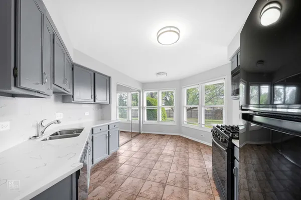 a kitchen with a sink appliances and cabinets