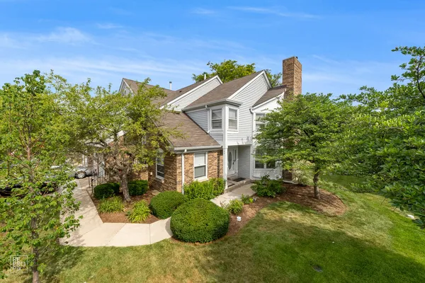 a view of a house with a backyard and a garden