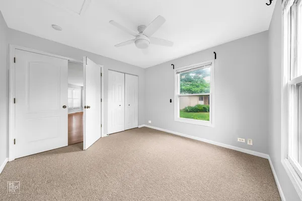 a view of a livingroom with a ceiling fan and window