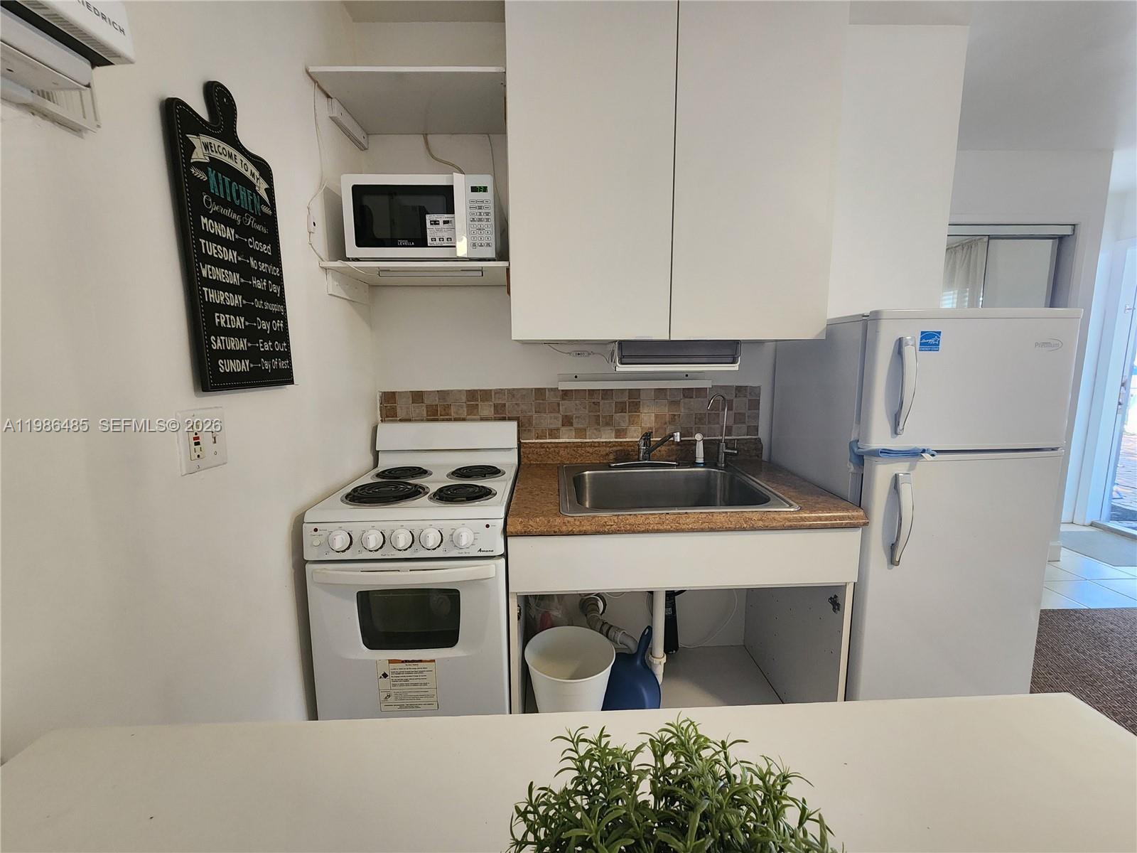 315 Walnut Street, Unit 2 Hollywood, FL 33019 - Photo 11 of 23 a kitchen with a stove and a refrigerator