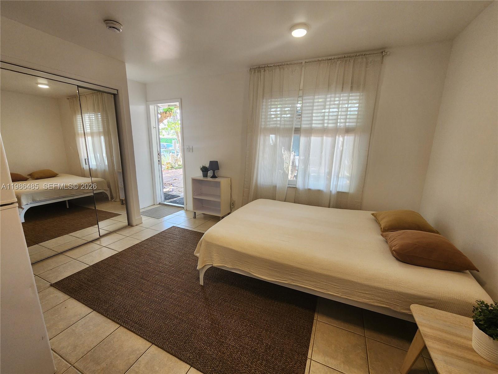 315 Walnut Street, Unit 2 Hollywood, FL 33019 - Photo 12 of 23 a spacious bedroom with a bed and large windows