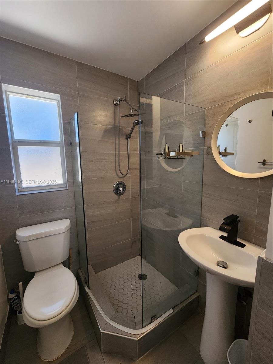 315 Walnut Street, Unit 2 Hollywood, FL 33019 - Photo 15 of 23 a bathroom with a toilet sink and shower