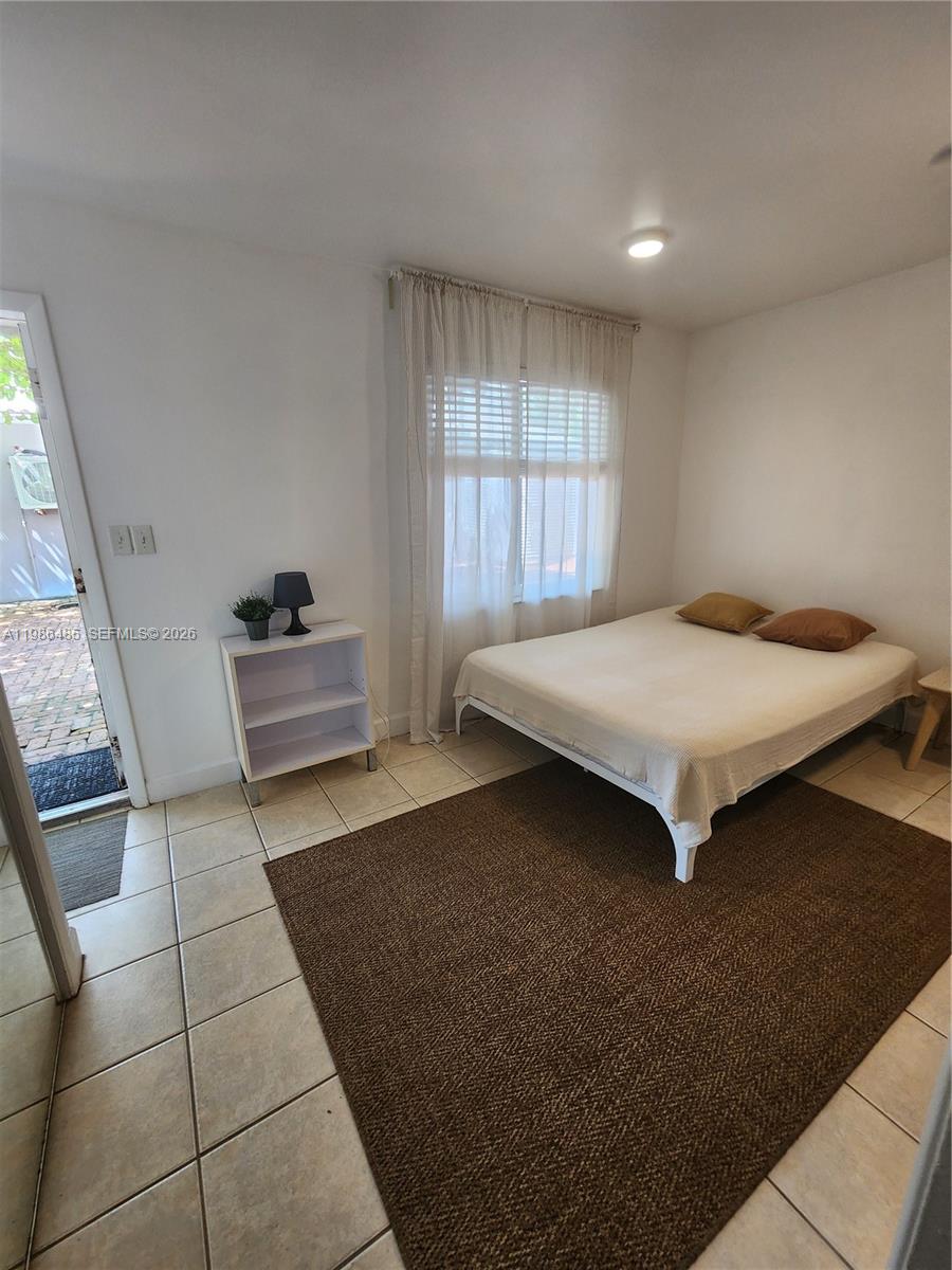 315 Walnut Street, Unit 2 Hollywood, FL 33019 - Photo 19 of 23 a bedroom with a bed and window